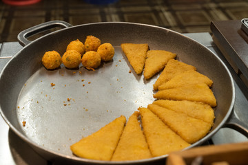 fried potato dishes lie in a pan in a Belarusian restaurant
