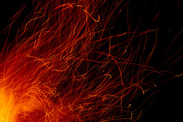 flame of fire with long sparks on a black background