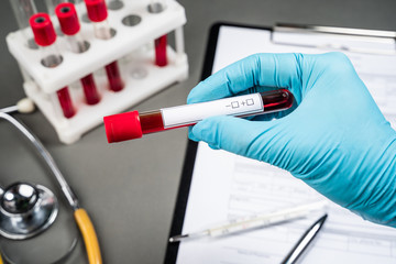 Blood vial with blood sample on test form