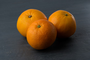 Organic oranges on slate background