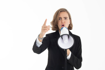 Naklejka premium Young business woman is shouting through a megaphone on white isolated background.