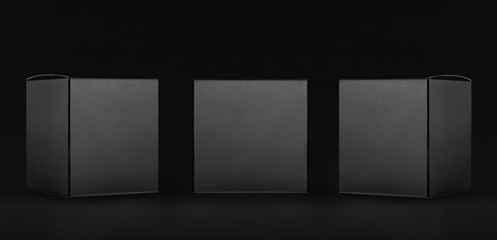 Exquisite collection of square black paper boxes  - side, front view on dark black background, mock...