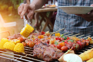 Barbeque Grill Street Food in thailand,Eat outdoors in a happy family. - obrazy, fototapety, plakaty