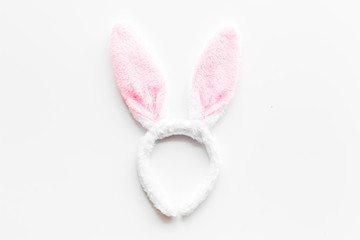 Easter bunny concept. Toy rabbit's ears for head on white background top-down copy space