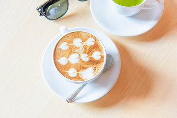 hot coffee on table / hot cappuccino with nice pattern milk foam 