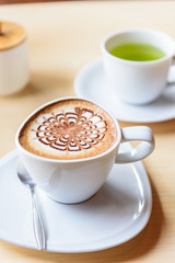hot coffee on table / hot cappuccino with nice pattern milk foam 