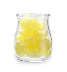 Tasty small lemon drops in glass jar isolated on white