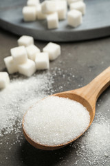 Fototapeta na wymiar Composition with granulated sugar on grey table