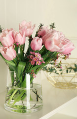 Beautiful bouquet with spring pink tulips on shelf