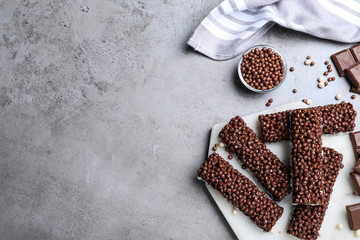Delicious rice crispy treats on grey table, flat lay. Space for text