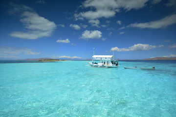 Traditional style white boat in the turquoise waters of Komodo National Park. Flores, East Nusa...