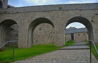 Fototapeta na wymiar Big stone walls, gate and bridge at Dinan fortress, France