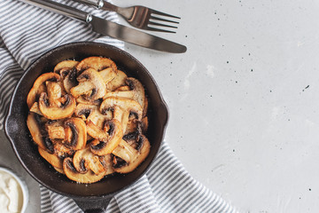 Delicious fried mushrooms with flat bread and herbs on the wooden table
