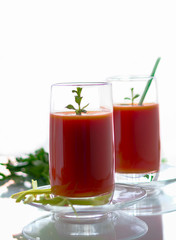 Fototapeta na wymiar Fresh tomato juice with carrots and celery, vertical orientation