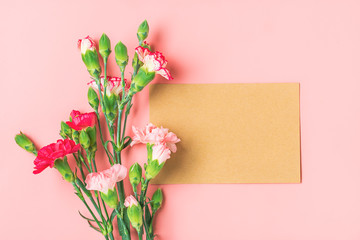 colorful bouquet of different pink carnation flowers, white notebook on pink background Top view Flat lay Holiday card 8 March, Happy Valentine's day, Mother's day concept Mock up