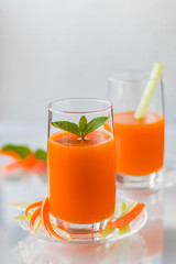 Freshly squeezed carrot juice with celery, vertical orientation