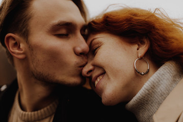Love. Close up portrait of young happy couple kissing