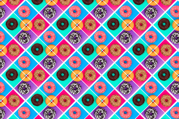 Pattern of pink, white and chocolate donuts on multi-colored background top view, tasty doughnuts backdrop, colorful sweet dessert wallpaper, creative repeating geometric decorative ornament
