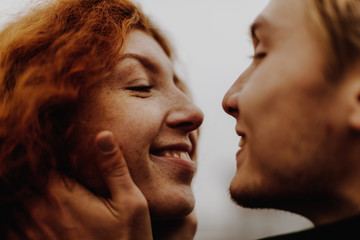 Love. Close up portrait of young happy couple kissing