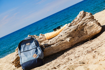 Tourist rucksack on a sandy tropical beach.