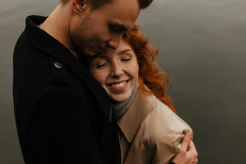 Cozy embrace. Feeling love. Portrait of beloved  couple standing togeter