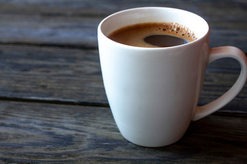 Cup of coffee in a white cup on an open background