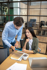 Two employees working in the office and looking involved