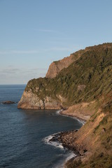 coast landscape with a mountain over the sea with waves a summer afternoon