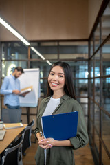 Fototapeta premium Asian young businesswoman with long hair looking contented