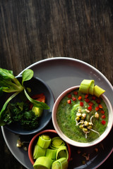 Creamy texture of green in a bowl with green vegetables spinach, broccoli and peas