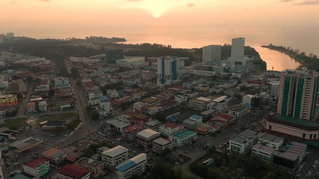 Aerial view sunset at Miri city, bay commercial area modern vehicle transport highway