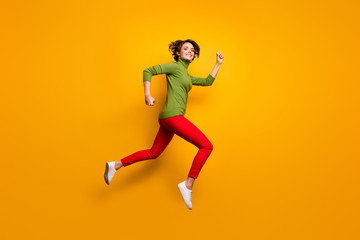 Fototapeta na wymiar Full length profile side photo of cheerful enthusiastic girl jump run after fall spring season discounts wear casual style clothing isolated over bright color background