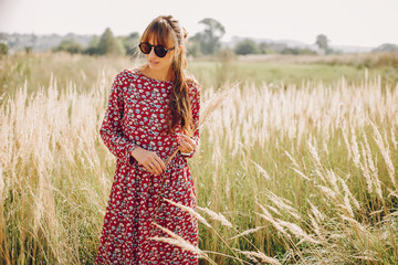 Beautiful girl in a park. Stylish girl in ared dress