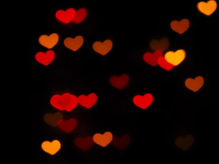 Fototapeta na wymiar Red heart shaped bokeh on black background. Valentine's day,love,anniversary concept..