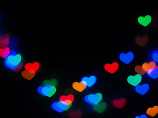 Blurred light colorful heart shaped on black background. Concept valentine's day,love,anniversary..