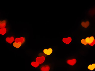 Fototapeta na wymiar Red heart shaped bokeh on black background. Valentine's day,love,anniversary concept..