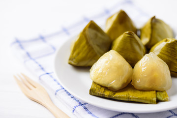 Thai dessert (Khanom Tian), sweet stuffed dough pyramid wrapped by banana leaf