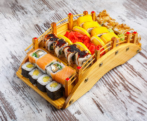 Large set of Japanese rolls on wooden serving board