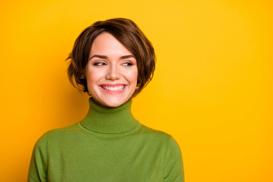 Closeup photo of short hairdo pretty lady charming smiling good mood looking side empty space sly eyes wear casual green warm turtleneck isolated yellow color background