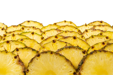 Pineapple juicy yellow slices background. Top view.