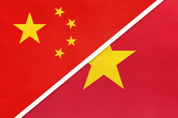 People's Republic of China or PRC vs Vietnam national flag from textile. Relationship between two asian countries.