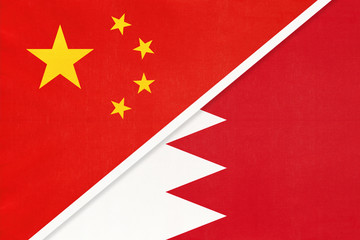 People's Republic of China or PRC vs Bahrain national flag from textile. Relationship between two asian countries.