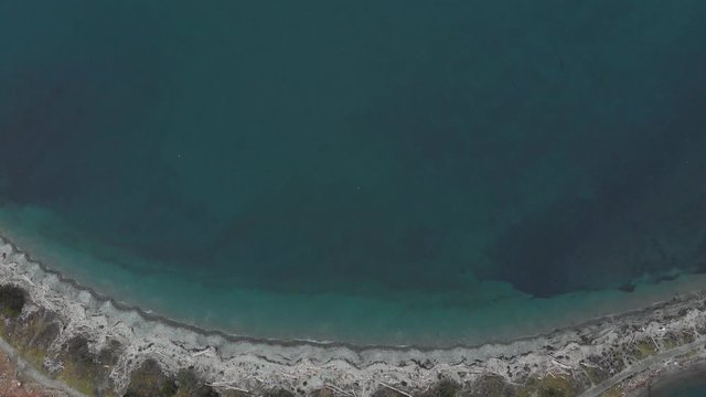 Aerial footage of Whiffin Spit in Sooke, BC, beside a turquoise blue ocean on Vancouver Island. 4K 24FPS.