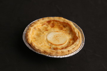 Delicious three cheese quiche in colored background