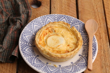 Delicious three cheese quiche in colored background