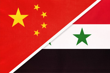 People's Republic of China or PRC vs Syria national flag from textile. Relationship between two asian countries.