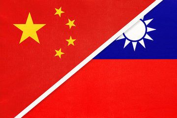 People's Republic of China or PRC vs Taiwan national flag from textile. Relationship between two asian countries.