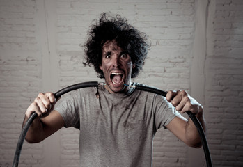 Funny image of man getting electric shock with funny face and smoke all around. DIY concept