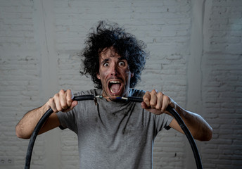 Funny image of man getting electric shock with funny face and smoke all around. DIY concept