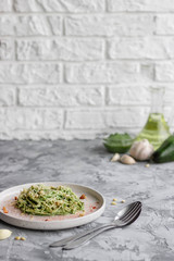 Green pasta with avocado, spinach and pine nuts